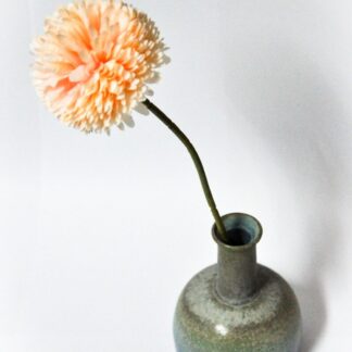 a small vase with a flower in it